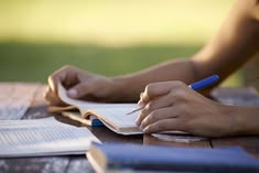 Person writing outdoors